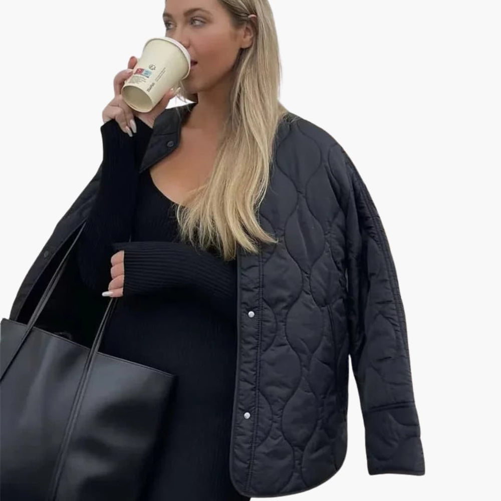 Women's winter puffer jacket with quilted padding and snap closure