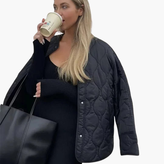Women's winter puffer jacket with quilted padding and snap closure